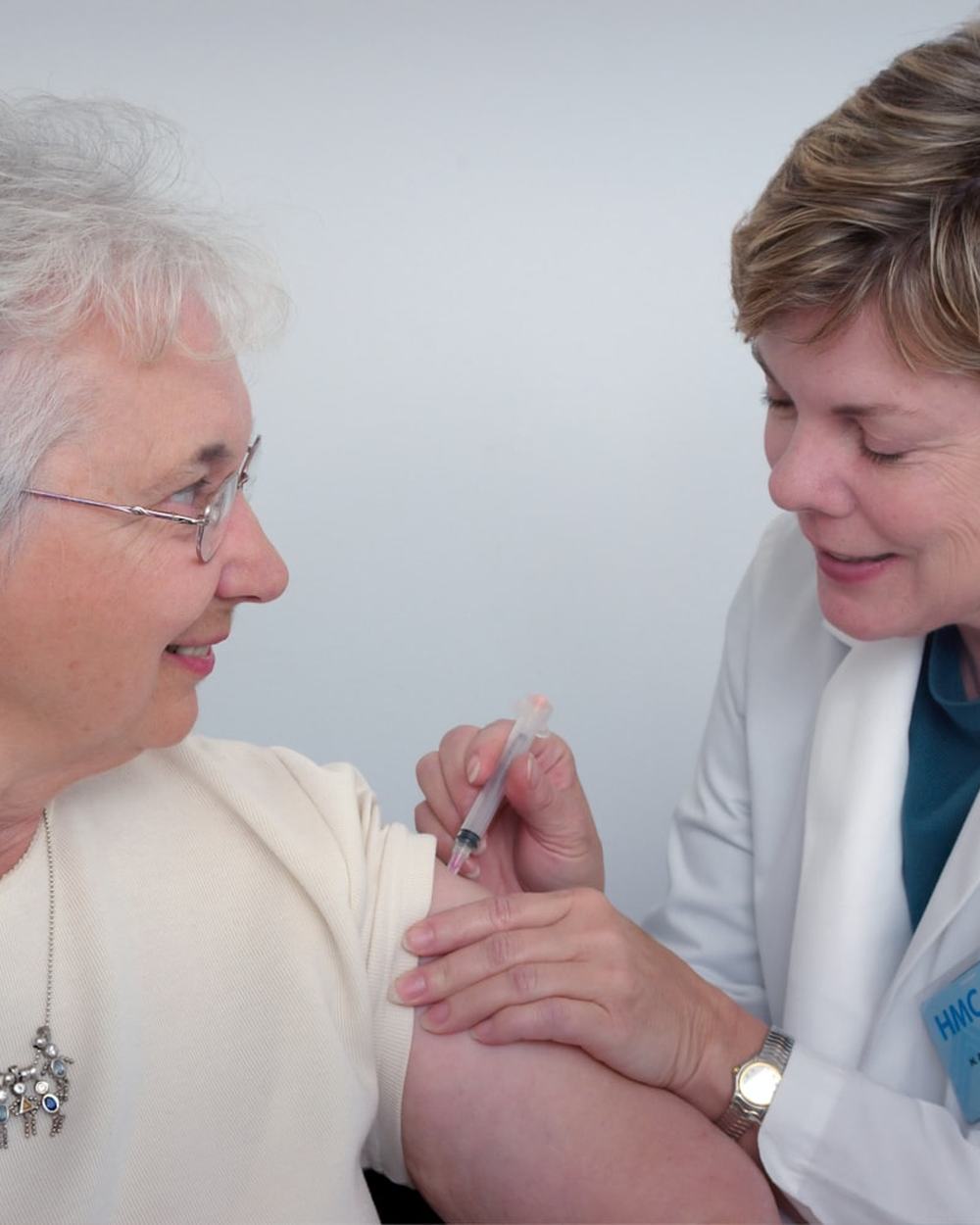 An occupational therapist assessing a client's shoulder and arm movement during a consultation.